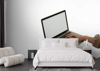 Woman using a laptop computer with blank screen isolated on white background. Wall mural