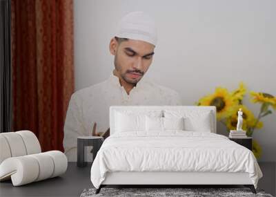 Muslim Man Writing in Notebook Wall mural