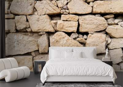 Beige stone wall background. Beige stone wall background. The texture of the stone wall. Wall mural