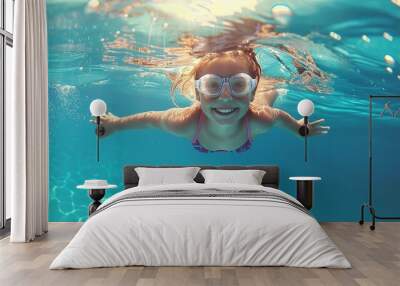 cheerful young girl enjoys swimming and diving underwater in pool. child engaged in swimming lessons during summer vacation Wall mural