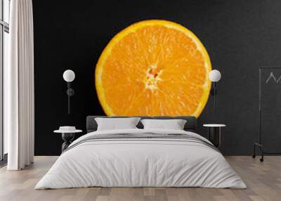 orange half on black background with directional light Wall mural