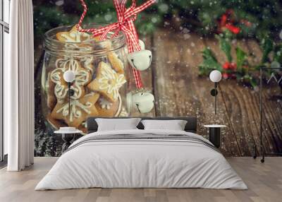 Christmas Cookies in a jar on Wooden background with snow and Christmas Holly  Wall mural