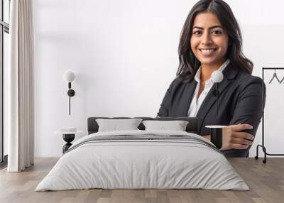 A professional female entrepreneur from the Middle East posing confidently with folded arms in a business suit, against a white background. Wall mural