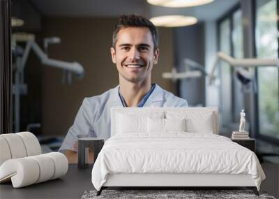 Cheerful male dentist in dental office. Confident portrait of a youthful dental practitioner in his examination room. Wall mural