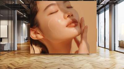 Facial care. Smiling Asian woman with flawless skin portrait. Beautiful girl with organic makeup shows off her radiant, moisturized complexion on neutral background. Premium quality. Wall mural