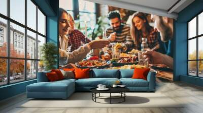 Joyful group of pals enjoying pasta at a home gathering - Happy individuals sharing a meal - Lifestyle idea with friends and acquaintances commemorating turkey day - Vibrant edit. Wall mural