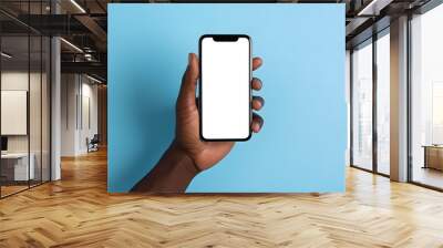 Male or Female hands holding smartphone with blank white screen isolated on blue background. Black man using device. Copy space. Mockup or Template for Presentation. Generative Ai. Wall mural