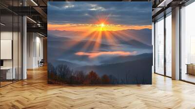 Morning light peeks through the misty peaks. Wall mural