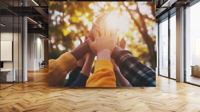 Panoramic assortment of diverse individuals united as a successful team, celebrating with a group high five and raised hands, representing teamwork Wall mural