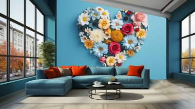 Beautiful flowers form a heart on a blue background Wall mural