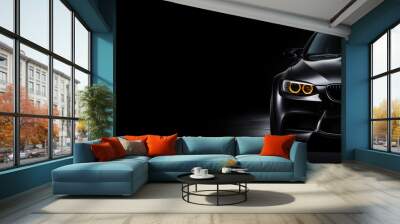 Black generic and unbranded sport car isolated on a black background Wall mural