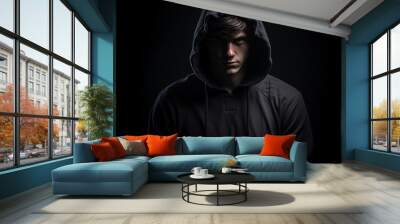 Young man man in hoodie on a dark background Wall mural