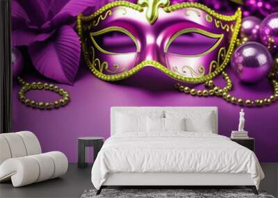 Close-up of the carnival mask and beads for the festive Mardi Gras masquerade on a purple background. A Fat Tuesday carnival with a traditional decor a place for text at the bottom Wall mural