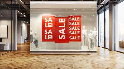 Sale sign on red banners with mannequins in window display of fashion shop store, black friday sale in promo showcase Wall mural