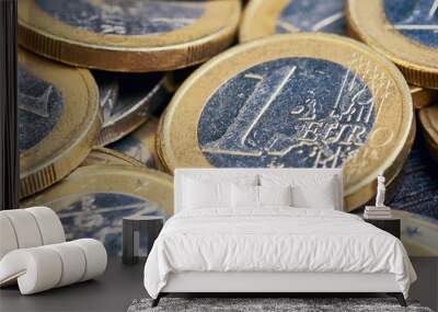 close up of one Euro coin in between other Euro coins Wall mural