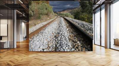 Railway in the mountains with heavy sky Wall mural