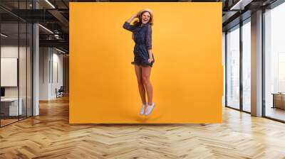 Full length body size view photo pretty lovely girl impressed astonished new sneakers shoes scream shout summer feel satisfied content rejoice dressed in modern clothing isolated yellow background Wall mural