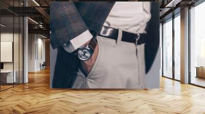 Vintage smart casual outfit outdoor.Fashion model man posing in office.Suited man posing.closeup fashion image of luxury watch on wrist of man.body detail of a business man.Not isolated. Wall mural