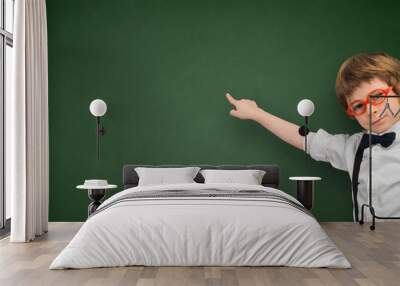 Boy points his finger at an empty blackboard banner Wall mural