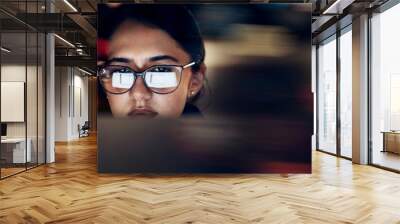 Woman, glasses reflection and computer at night for planning, website search and technology. Face of female working late on desktop, dark office and reading online network, focus vision and internet Wall mural