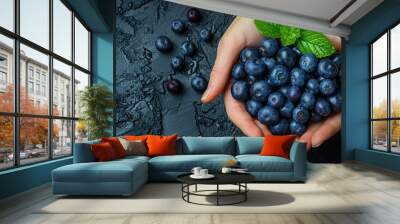 acai berries held in hand Wall mural