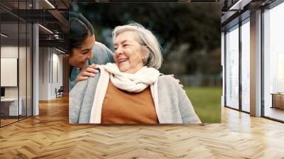 Caregiver helping woman with disability in park for support, trust and care in retirement. Nurse talking to happy senior patient in wheelchair for rehabilitation, therapy and conversation in garden Wall mural