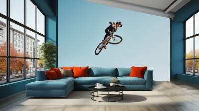 Motorcycle stunt, man cycling in air jump on blue sky mock up for sports action performance, fitness training or outdoor bike performance. Professional sports person with bmx bicycle adventure mockup Wall mural