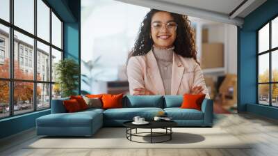 Portrait, business woman and fashion designer with arms crossed in clothes store or startup. Confidence, happy tailor and face of professional, entrepreneur and creative worker in glasses in Brazil Wall mural