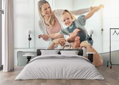 Airplane, fantasy and parents playing with child on a couch in a home together and bonding as a family with love. Care, happiness and kid happy with mother and father on a sofa for fun Wall mural