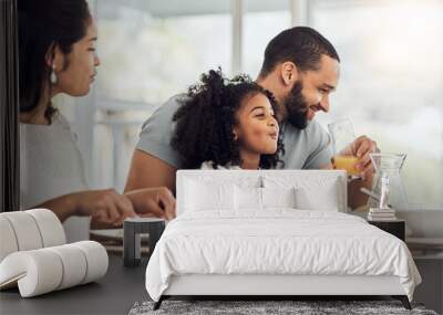 Happy family, breakfast and eating at table in home, talking or discussion together. Love, support and comic man, woman and girl child laughing, care and bonding drinking orange juice and having food Wall mural