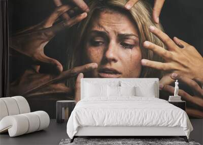 Many hands, face and abuse with a woman victim feeling fear, alone or crying in studio on a dark background. Sad, pain and violence with a scared female suffering with stress or social anxiety Wall mural