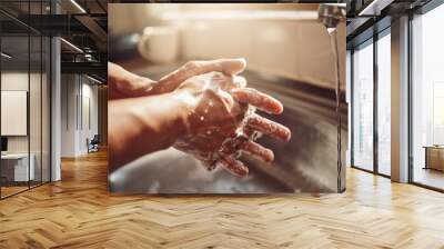 No germs, no problem. Shot of an unrecognisable man washing his hands in the kitchen sink at home. Wall mural