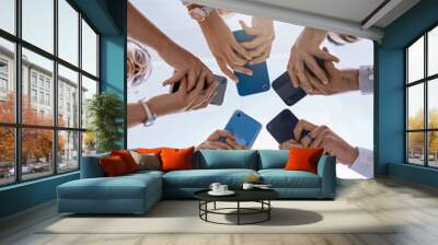 Social media, smartphone and business people networking with a global community using technology together. Group and team typing, surfing and searching online on web communication app from below view Wall mural