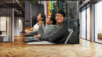  young people in boardroom and coworking shared office using computers working on computer Wall mural