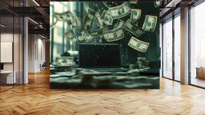 A laptop is on a table with a pile of money and a pile of money flying out of it Wall mural