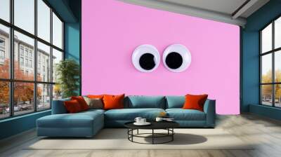 googly eyes funny cute Isolated on bright light pink background copy space logo Wall mural