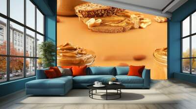 Delicious peanut butter spread on whole grain bread surrounded by almonds in a rustic, warm setting. Perfect for lifestyle and food visuals. Wall mural