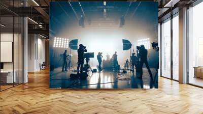 commercial video film movie making lighting set professional studio production big working people silhouette scenes behind television camera motion picture equipment crew photo light  Wall mural