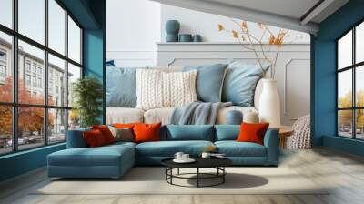 A cozy blue living room with a plush velvet sofa and a fireplace. Wall mural