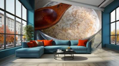 Making oatmeal porridge. Oats cooking in a pot. Healthy breakfast. Wall mural