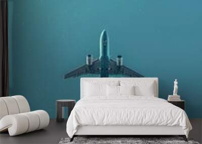 Passenger plane soaring with a clear sky for copy space. Wall mural