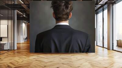 Rear shot of a young businessman. Wall mural