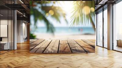 Empty wooden table and palm leaves with party on beach blurred background in summer time Wall mural