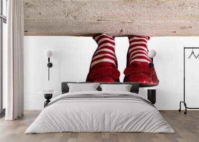 Red and white stripe socks with red ruby slippers isolated under a wood board Wall mural