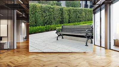 Wood park bench in a garden setting Wall mural