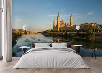 View of the cathedral of El Pilar de Zaragoza, next to the river Ebro, at sunset. Wall mural