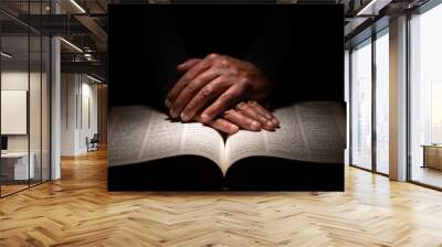 African American Man Praying with Hands on Top of the Bible Wall mural