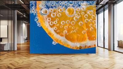 orange in water, a slice of orange submerged in a clear, bubbly liquid Wall mural