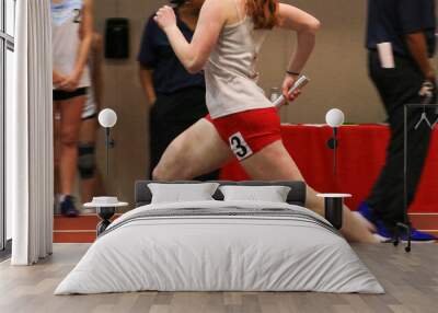 female runner running fast on an indoor track Wall mural