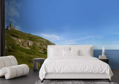 view on sweden coast with a  lighthouse at the top of a hill face to baltic  sea on blue sky and white clouds Wall mural